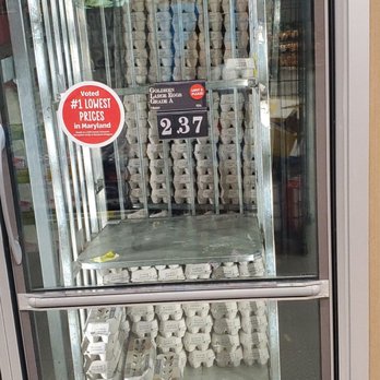 ALDI - Eggs (the price fluctuates, but this price is good compared to traditional stores) - Egg cartons are stacked inside a glass display case at a store, with a sign indicating the price and quality of eggs. - Grocery Near Me - Laurel, Maryland