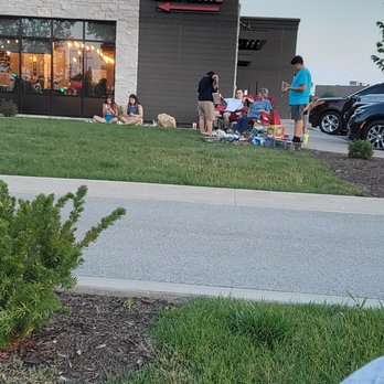 Baja Tacos and Shots - a man sitting in front of a restaurant - Mexican Near Me - Bettendorf, Iowa