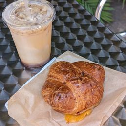 A Lavender Honey Oat Milk Latte and Ham and Cheese Croissant A Lavender Honey Oat Milk Latte and Ham and Cheese Croissant