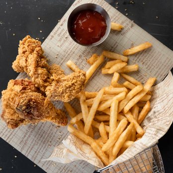 WOW Chicken - a basket of french fries and a bowl of ketchup - Korean Near Me - Calgary, Alberta
