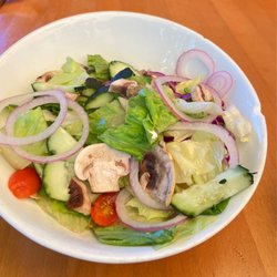 Riverside Grill & Bar - House salad. Chipped bowl with wilted leaves and discolored mushrooms.