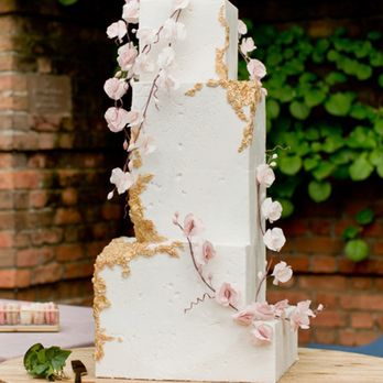 Flourish Cake Design - a three tiered white cake with pink flowers - Custom Cakes Near Me - Chicago, Illinois