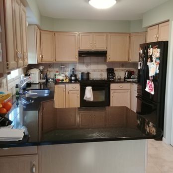 Tekton Management - a kitchen with black appliances - General Contractors Near Me