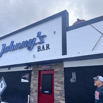 Boston Johnny's - a man standing in front of a bar - Sports Bars Near Me - Hollywood, Florida