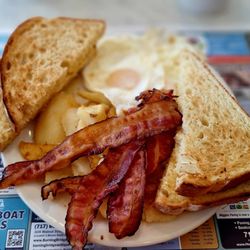 Hinkle's Restaurant - Eggs over easy ( dippy) with bacon, home fries and toast with coffee.