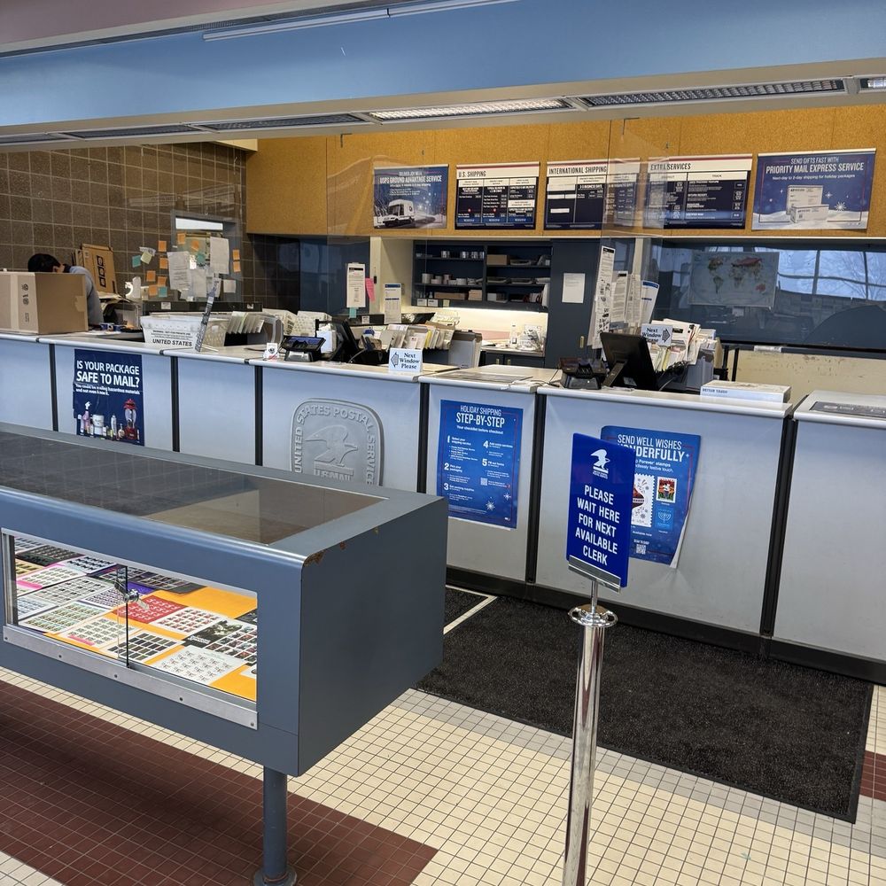 US Post Office - Front counter with most of the overhead lights burnt out. - Post Offices Near Me - Minneapolis, Minnesota