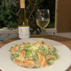 Chicken Caesar salad and pine crest Chardonnay