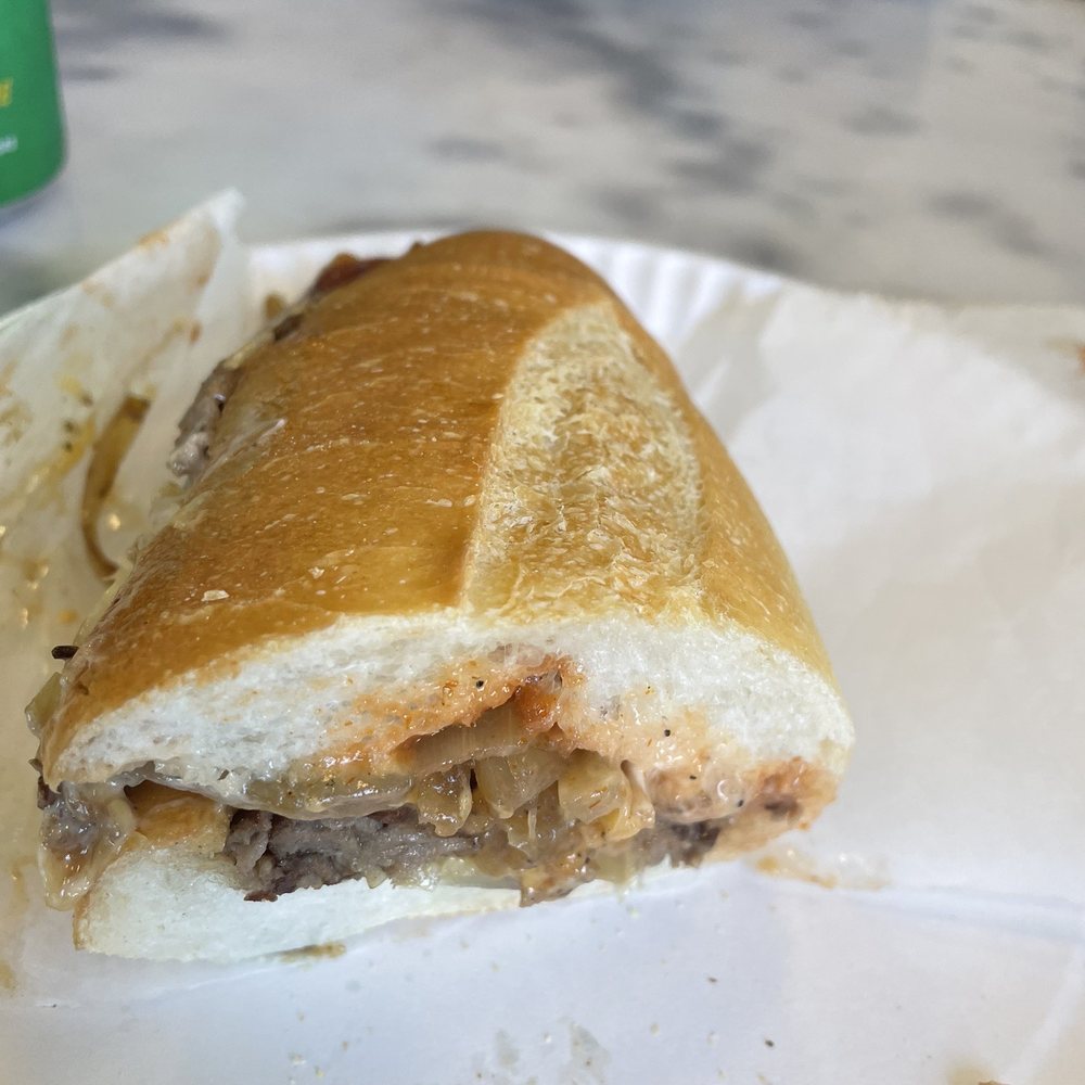 Queen Pizza - a half eaten sandwich on a paper plate - Pizza Near Me - Newark, New Jersey