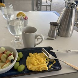 Scrambled eggs with fruit bowl and coffee Scrambled eggs with fruit bowl and coffee