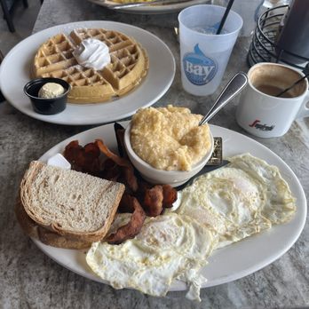 Bay Local Eatery - THE LESNER 1 waffle, 2 eggs any style*, applewood smoked bacon, cheese grits and rye toast. - New American Near Me - Virginia Beach, Virginia