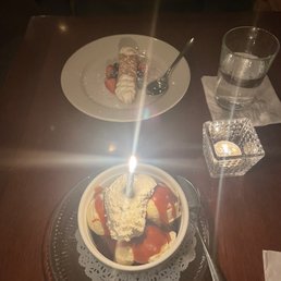 a plate of dessert with ice cream and strawberries