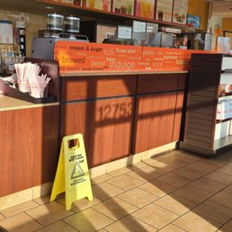 a sign in front of a restaurant counter a sign in front of a restaurant counter