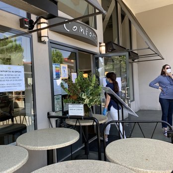 Comforts - a woman in a face mask standing outside a restaurant - Breakfast & Brunch Near Me - San Anselmo, California