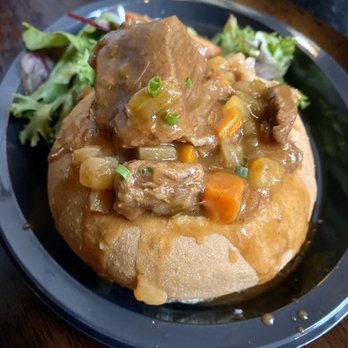 Leaky Cauldron™ - Beef, Lamb and Guinness Stew w/ salad - British Near Me - Orlando, Florida Leaky Cauldron™ - Beef, Lamb and Guinness Stew w/ salad - British Near Me - Orlando, Florida