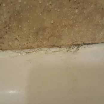 The Tiki - There was hair EVERYWHERE. This is a picture of it caked into the bathroom tub grout. - Resorts Near Me - Lake George, New York