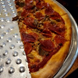 Rossini's Pizzeria & Restaurant - Delicious meat combo pizza. Well, half of it
