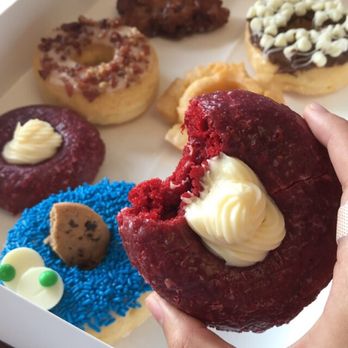 Donut Worry - Red velvet doughnut and a wide selection in the background! :) - Donuts Near Me - Lawrenceville, Georgia