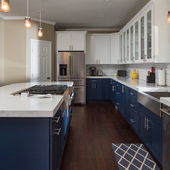 New Castle Building Group - a kitchen with blue cabinets and white countertops - General Contractors Near Me New Castle Building Group - a kitchen with blue cabinets and white countertops - General Contractors Near Me