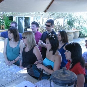 Ceja Vineyards - a group of people gathered around a table - Wineries Near Me - Napa, California