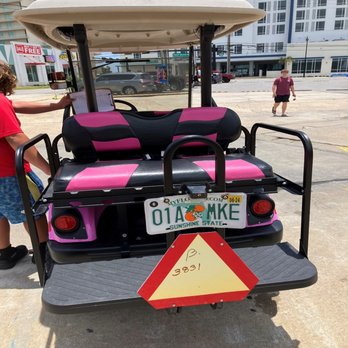Outlaw Rentals - Golf cart day of rental before leaving property with employee on left driver's side. - Motorcycle Rental Near Me - Panama City Beach, Florida Outlaw Rentals - Golf cart day of rental before leaving property with employee on left driver's side. - Motorcycle Rental Near Me - Panama City Beach, Florida