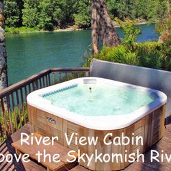 Harmony Lodge Cabin Rentals - River View Cabin hot tub at edge of deck over the Skykomish River