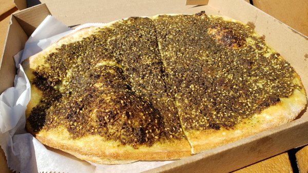 Photo of Filfillah Restaurant - Columbia Heights, MN, US. Zaatar pie ($7), vegan by default. Large and really fresh & tasty. Excellent spices, excellent chew on bread.