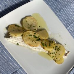 Moonlight - Half of a bronzino, plated with potatoes.