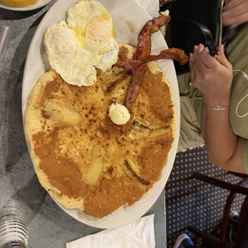 Hash House A Go Go - Vanilla Waffle, bacon and eggs, Banana pancakes, eggs over easy and bacon. - New American Near Me - Orlando, Florida Hash House A Go Go - Vanilla Waffle, bacon and eggs, Banana pancakes, eggs over easy and bacon. - New American Near Me - Orlando, Florida