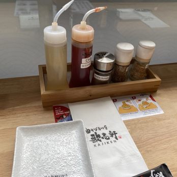 Kajiken - Condiments at the table. The garlic and sesame bottles are grinders! How neat - Japanese Near Me - Boston, Massachusetts Kajiken - Condiments at the table. The garlic and sesame bottles are grinders! How neat - Japanese Near Me - Boston, Massachusetts