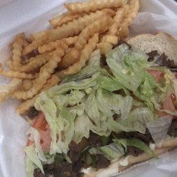 a sandwich and fries in a styrofoam container