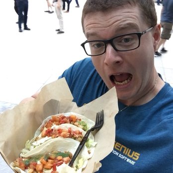 Arcane Kitchen - a man holding a plate of food - Food Trucks Near Me Arcane Kitchen - a man holding a plate of food - Food Trucks Near Me
