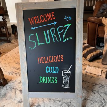 Slurpz - a chalkboard sign in a living room - Beverage Store Near Me Slurpz - a chalkboard sign in a living room - Beverage Store Near Me