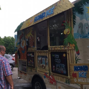 Kona Ice Truck - a man standing in front of it - Food Trucks Near Me Kona Ice Truck - a man standing in front of it - Food Trucks Near Me