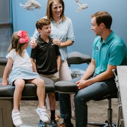Pediatric Dental Group & Orthodontics - Dr. Denson speaking with a young family about healthy smiles.