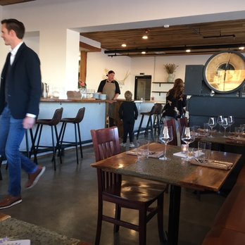 Farmers Grain Kitchen + Cellar - Bar seating in the center wraps around the bench seating. - New American Near Me - Edmond, Oklahoma Farmers Grain Kitchen + Cellar - Bar seating in the center wraps around the bench seating. - New American Near Me - Edmond, Oklahoma