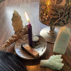 Crystal Raven - Smudge duck feather a fan, ocean jasper flame, purple ritual candle, palo santo, dragon head, and Caribbean calcite tower