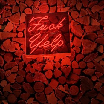 Sycamore Den - a neon sign in a wood pile - Cocktail Bars Near Me - San Diego, California Sycamore Den - a neon sign in a wood pile - Cocktail Bars Near Me - San Diego, California