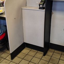 Employee on personal cell phone ignoring customer.