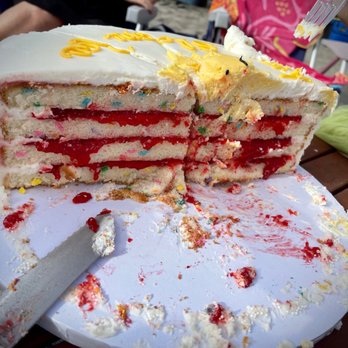 Carlsbad Bakery - The 4 tiers sliced in half, showing the delicious raspberry jelly filling, and the funfetti cake... so pretty! - Bakeries Near Me - Carlsbad, California