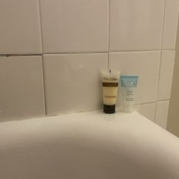 Broken tile,  shampoo and conditioner, crazy old military bathrooms, plastic glasses, yucky old water jugs near garbage in lobby.