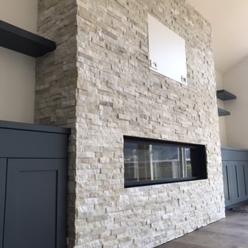 Dre's Tile & Stone - a fireplace in a living room - General Contractors Near Me