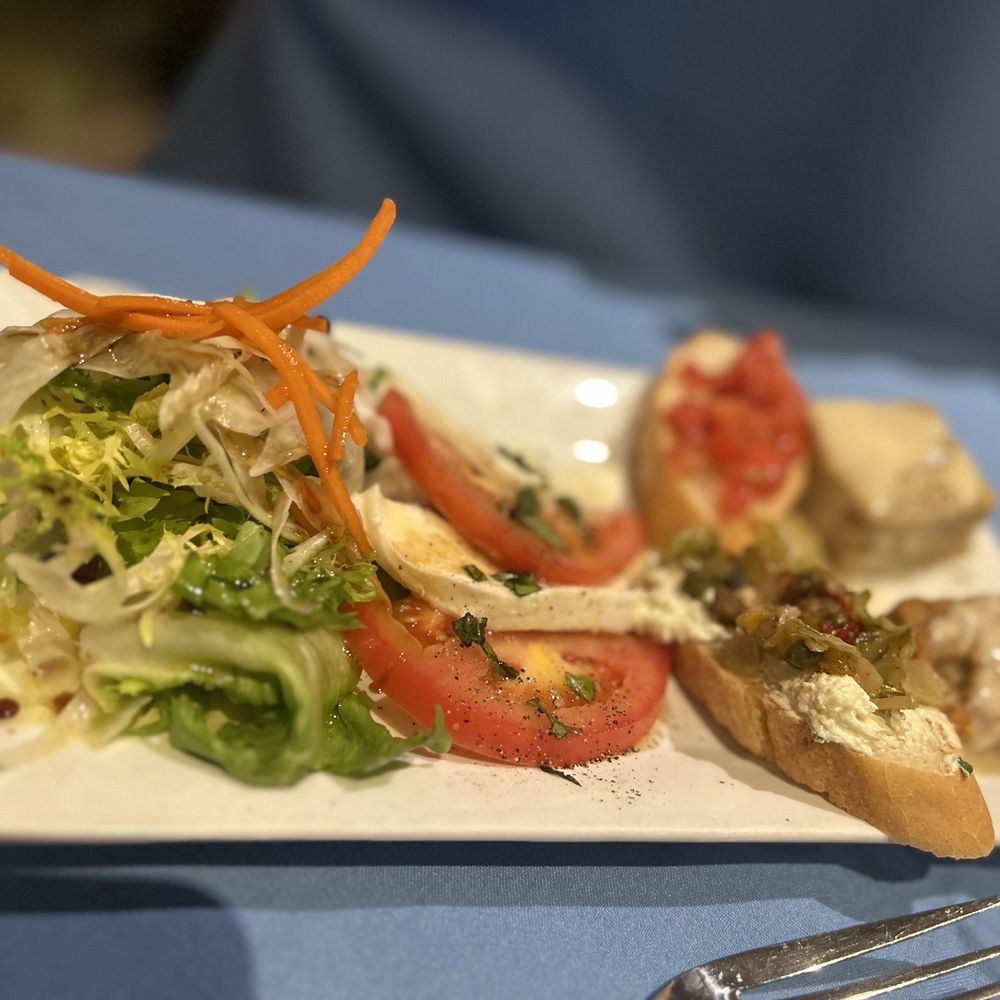 Parma - a plate of food on a table - Italian Near Me - Fresno, California Parma - a plate of food on a table - Italian Near Me - Fresno, California