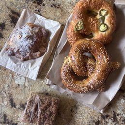 Twice-baked almond croissant, slice off coffee cake, and pretzels - everything and a cheddar jalapeño. Delicious.