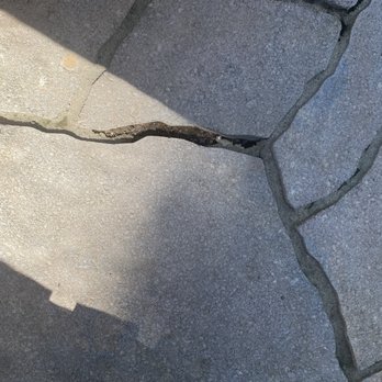 Calo Renovations - Cracks and raised areas in the stone patio. - Siding Near Me