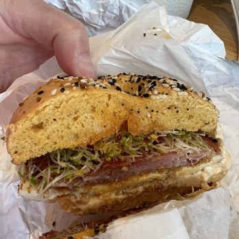 Goldstein's Bagels & Bialys - Spicy Boi: egg, prosciutto, Szechuan cream cheese, chili crisp, sprouts on an everything egg bagel - Bagels Near Me - Boise, Idaho Goldstein's Bagels & Bialys - Spicy Boi: egg, prosciutto, Szechuan cream cheese, chili crisp, sprouts on an everything egg bagel - Bagels Near Me - Boise, Idaho