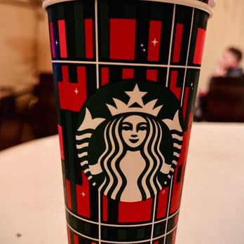 Starbucks - a starbucks cup on a table - Coffee & Tea Near Me - Chicago, Illinois