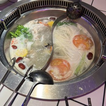 ER Hot Pot - Hot pot - chicken broth with coconut and seashells on the left and pork broth on the right. - Hot Pot Near Me - New York, New York ER Hot Pot - Hot pot - chicken broth with coconut and seashells on the left and pork broth on the right. - Hot Pot Near Me - New York, New York