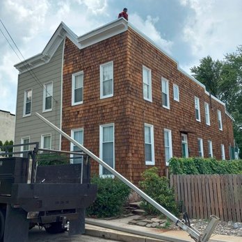 Luna Roofing & Siding - a large brown house with white windows - Roofing Near Me - Baltimore, Maryland