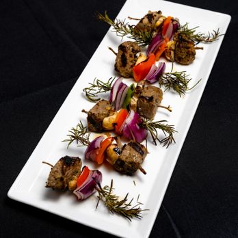 The Catering Company - Grilled Streak Skewer on a Rosemary Sprig Appetizer - Caterers Near Me The Catering Company - Grilled Streak Skewer on a Rosemary Sprig Appetizer - Caterers Near Me