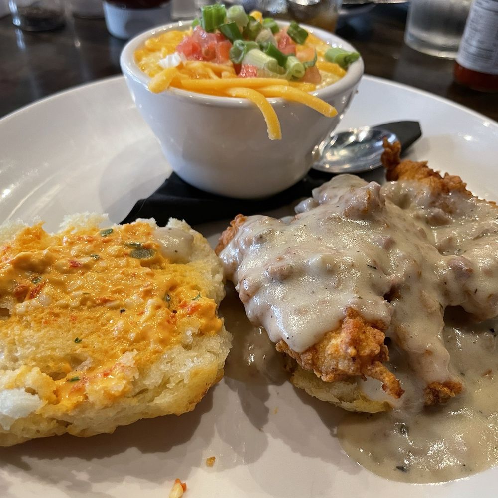 B Matthews Eatery - Chicken 'n biscuit with loaded grits of cheese, green onion, and diced tomatoes - New American Near Me - Savannah, Georgia B Matthews Eatery - Chicken 'n biscuit with loaded grits of cheese, green onion, and diced tomatoes - New American Near Me - Savannah, Georgia